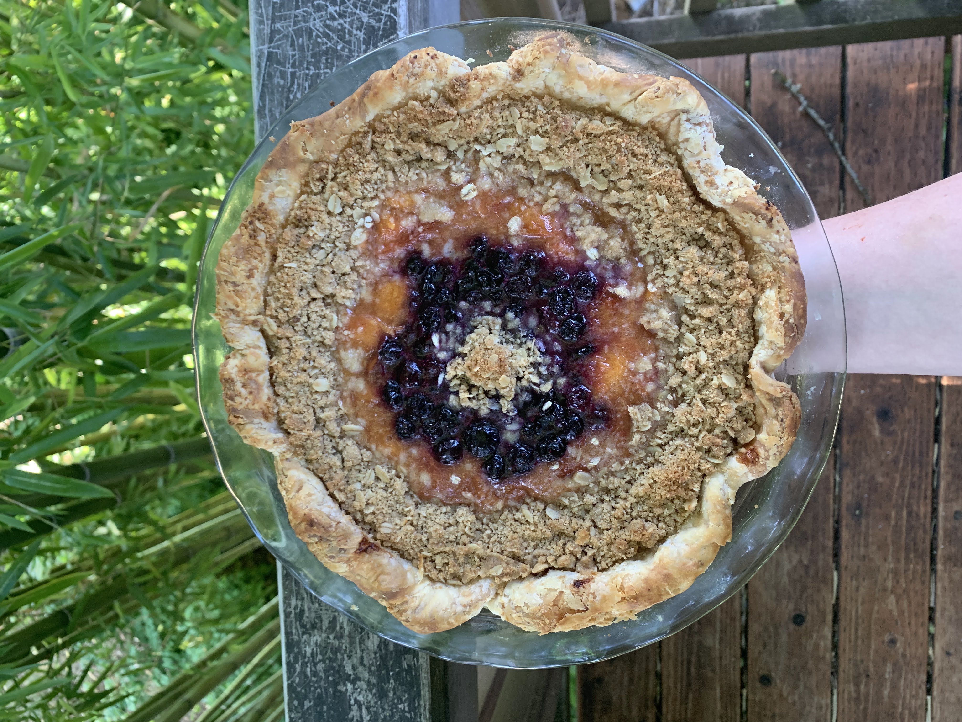 A blueberry nectarine pie with streusel in concentric circles around the pie.