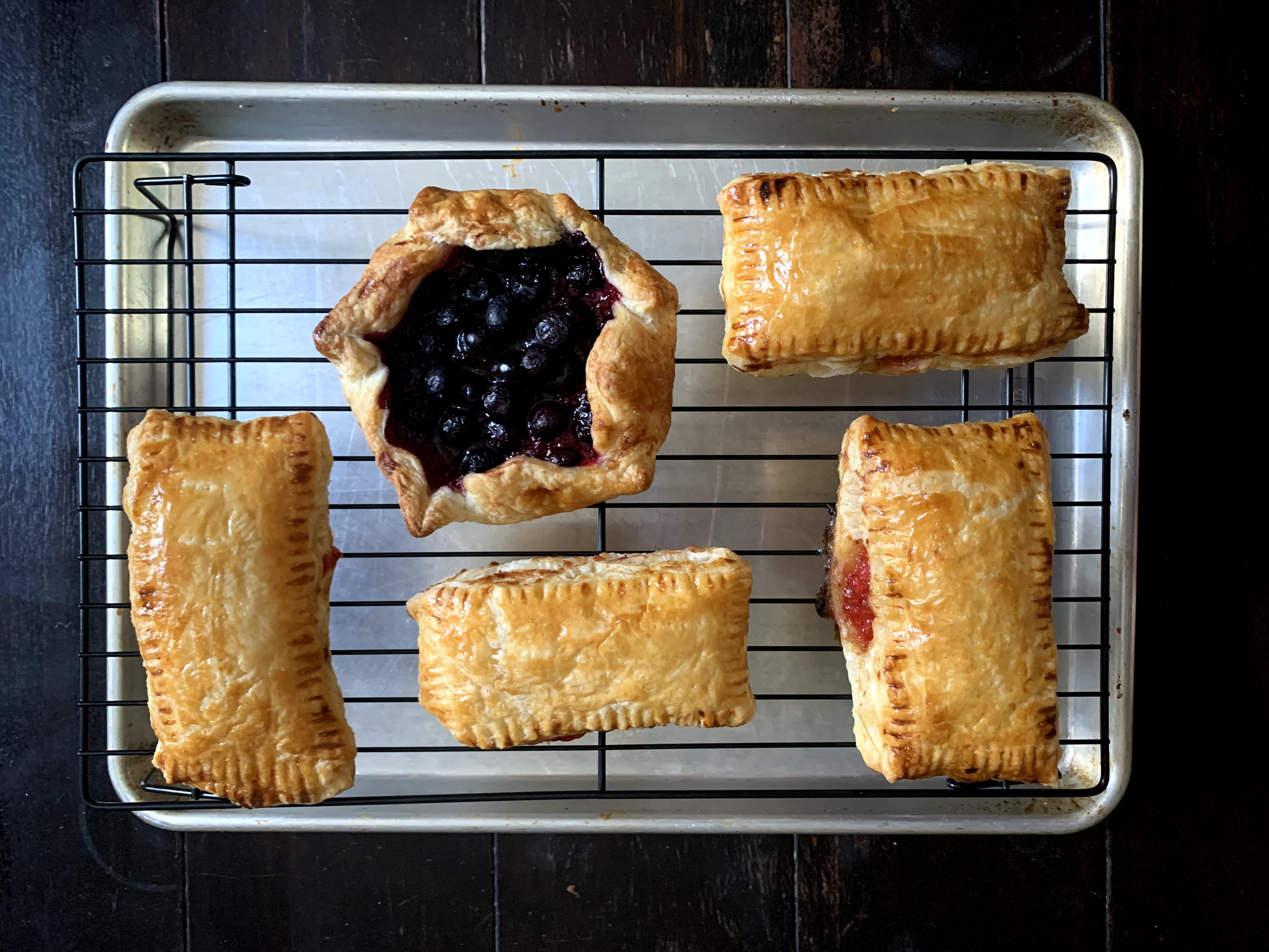Three homemade strawberry pop-tarts and one mini blueberry galette.
